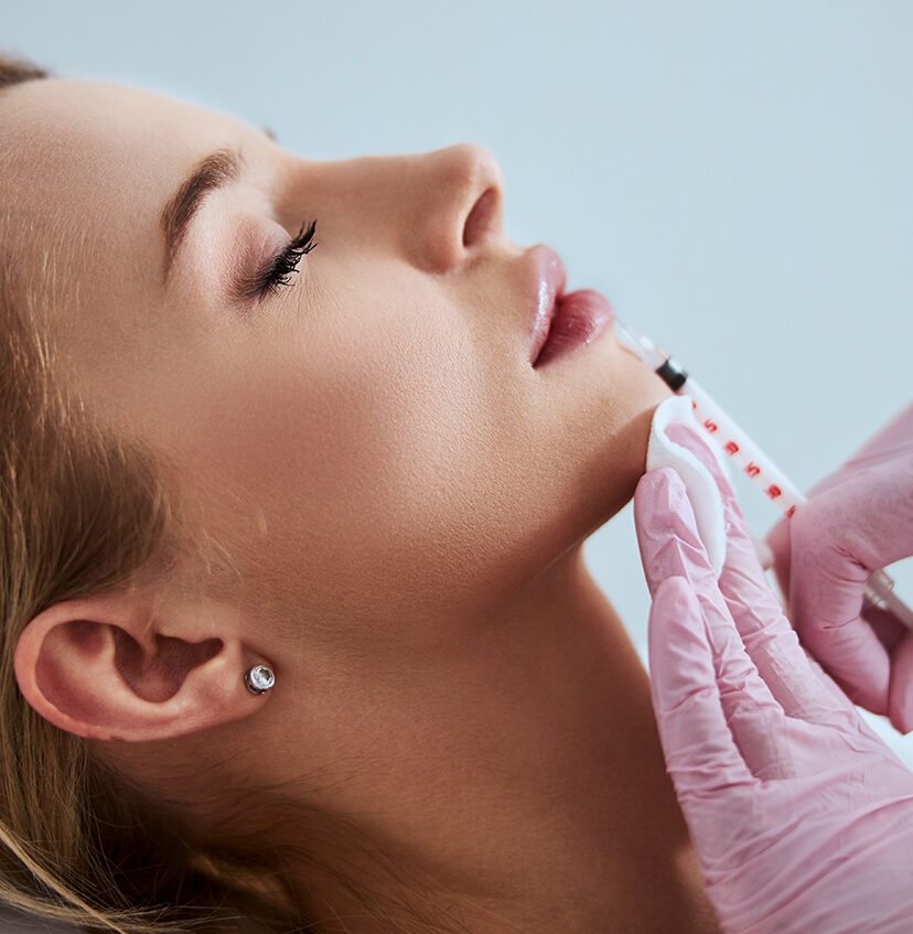 Photo of a woman receiving lip filler injections